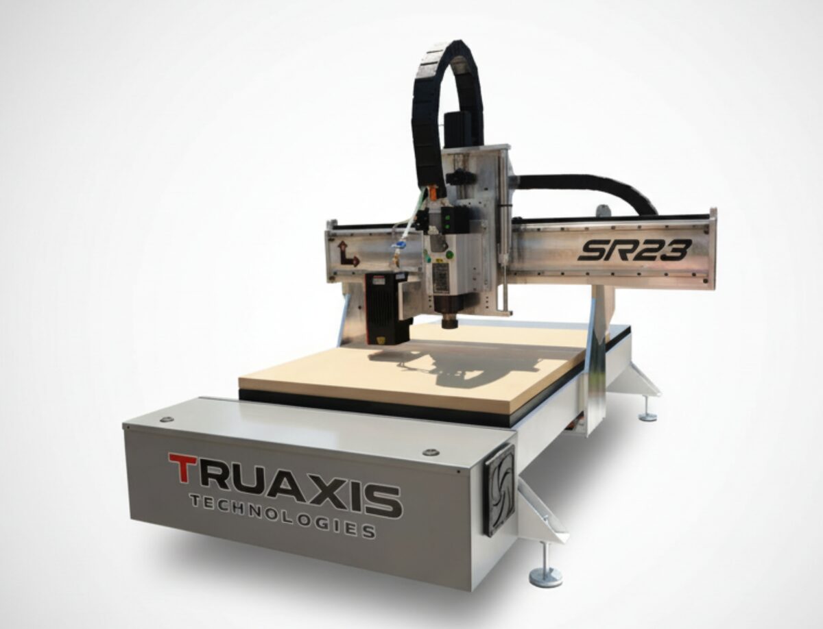 TruAxis Stinger 1 CNC router seen from the front left, a compact open-gantry machine over a flat cutting table.